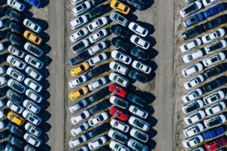 Specialized Hanamark truck loading auction vehicle for delivery.