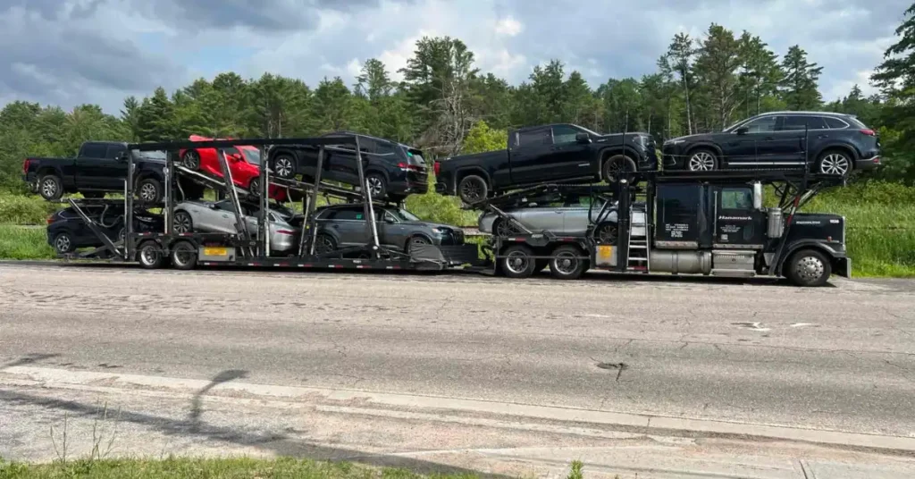 Large auto transport trailer hauling trucks and sedans during a long-distance car delivery to Vancouver.